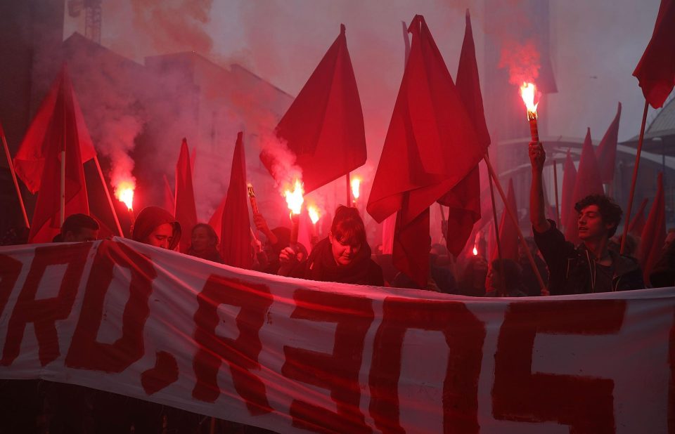  Protesters held flares and threw smoke bombs outside the Tory party conference