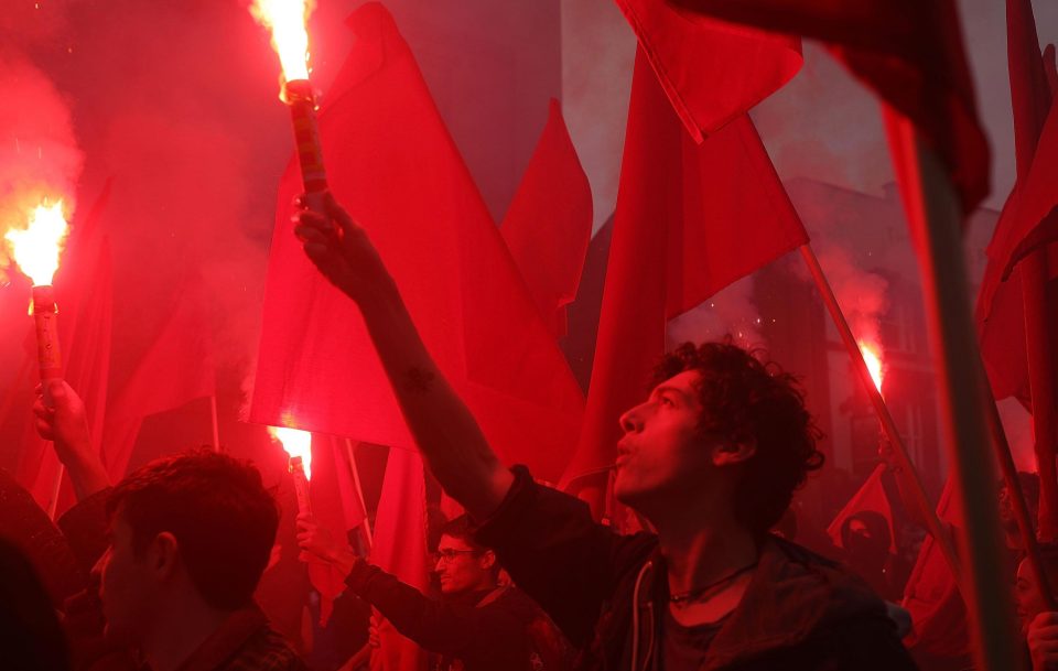  One protester lights a flare at the march