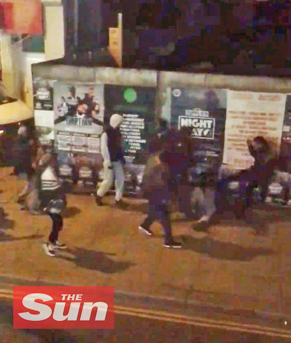  The group appear to lay into the young man on the pavement before scattering