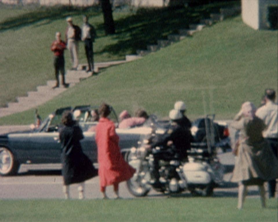 Jacqueline Kennedy cradles her husband President John F. Kennedy seconds after he was fatally shot