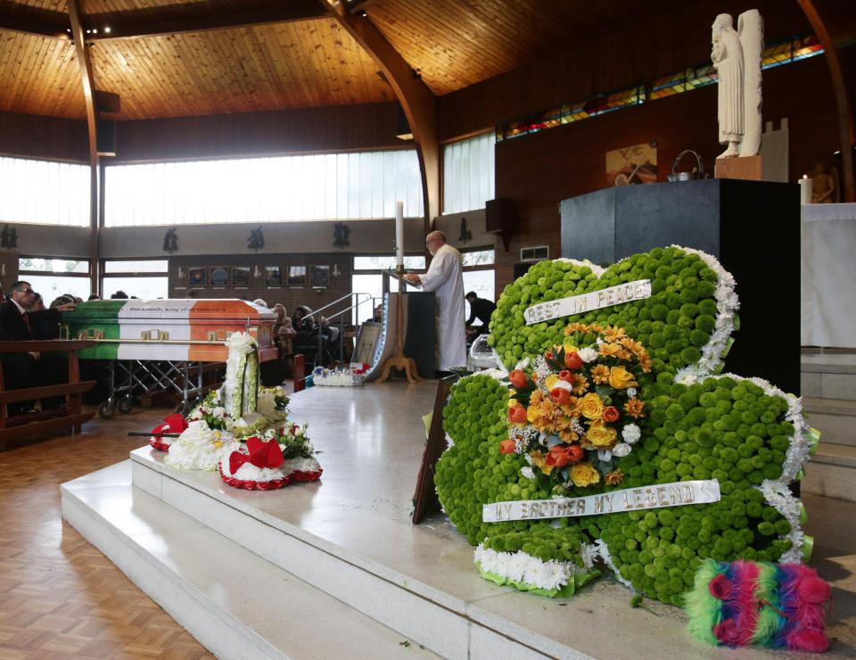  Floral tributes were laid on the altar in the shape of an Irish shamrock, bottles of whisky, pint of Guinness and a Rolls Royce