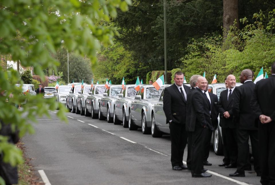  The cars bore Irish flags as they drove behind the hearse