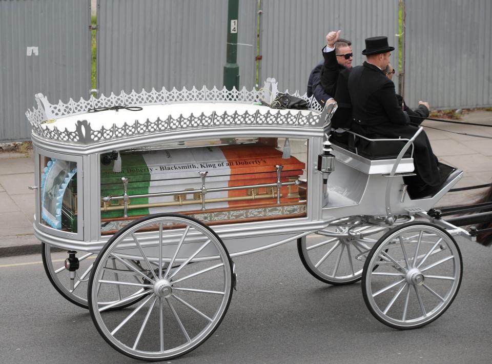  Mr Doherty's coffin was emblazoned with the colours of the Irish flag and the message: 'Simon Doherty - blacksmith, King of all Doherty's'