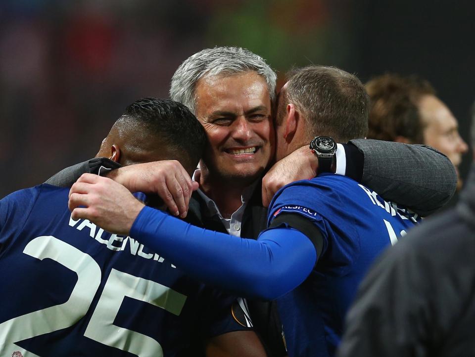  Mourinho hugs Valencia and Wayne Rooney after winning the Europa League