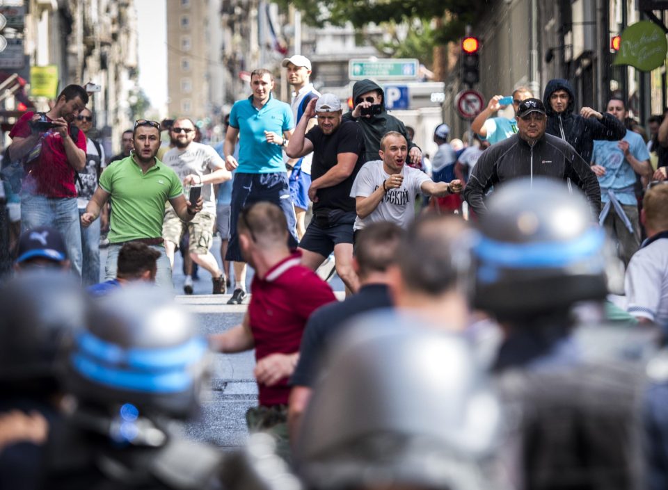  Russian supporters throw glass bottles as they clash with riot police before the England v Russia match in June 2016