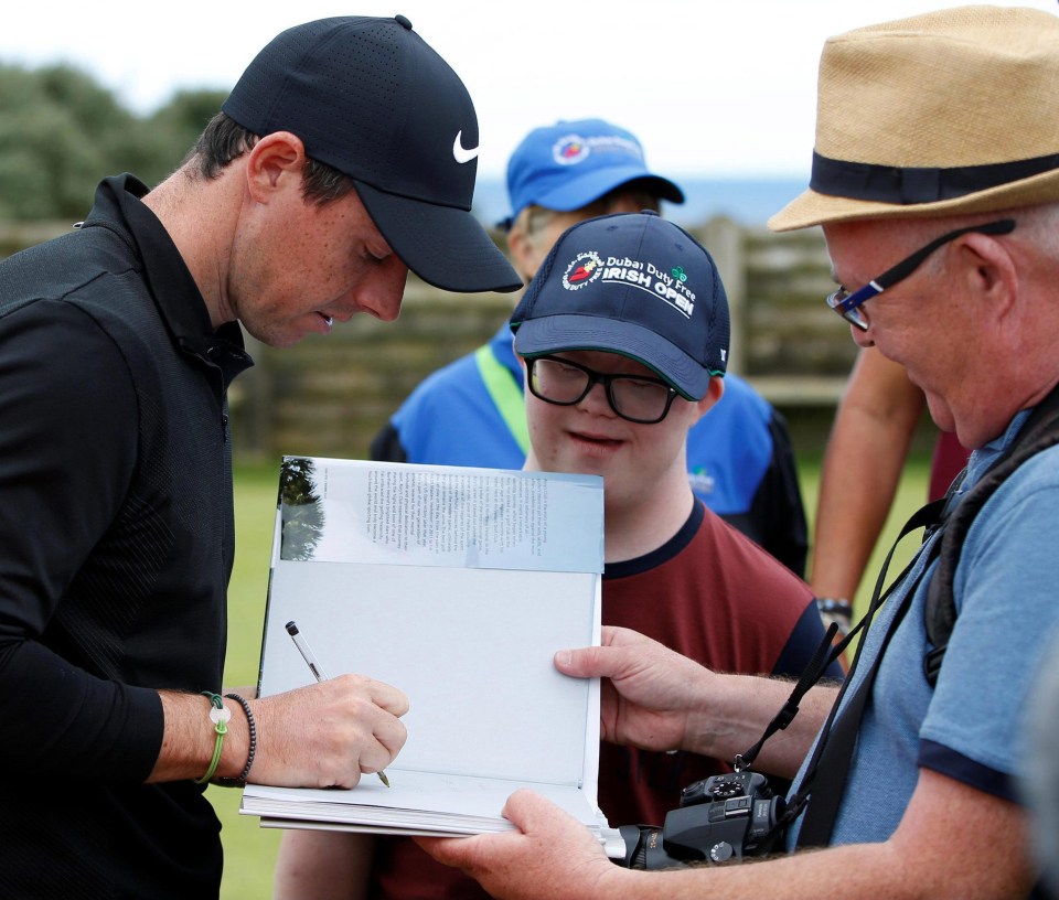 Rory McIlroy signs an autograph for a keen fan... unlike Roy Keane back in the day