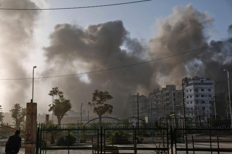  Smoke billows in the rebel-held town near Damascus following air strikes by Syrian government forces