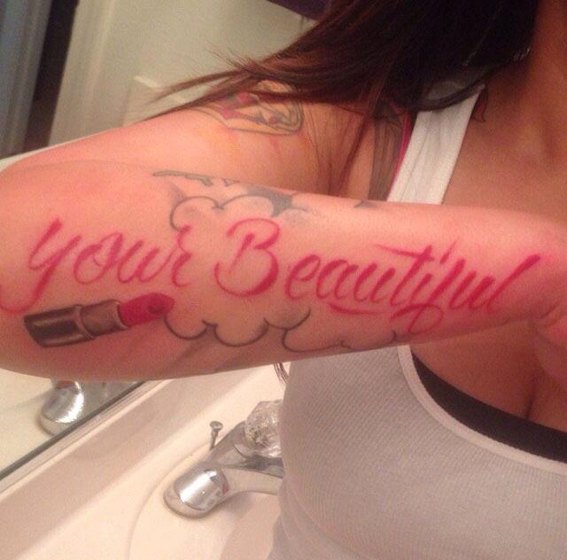  A woman shows off her cringe tatt spelling fail - it should be 'you're beautiful'