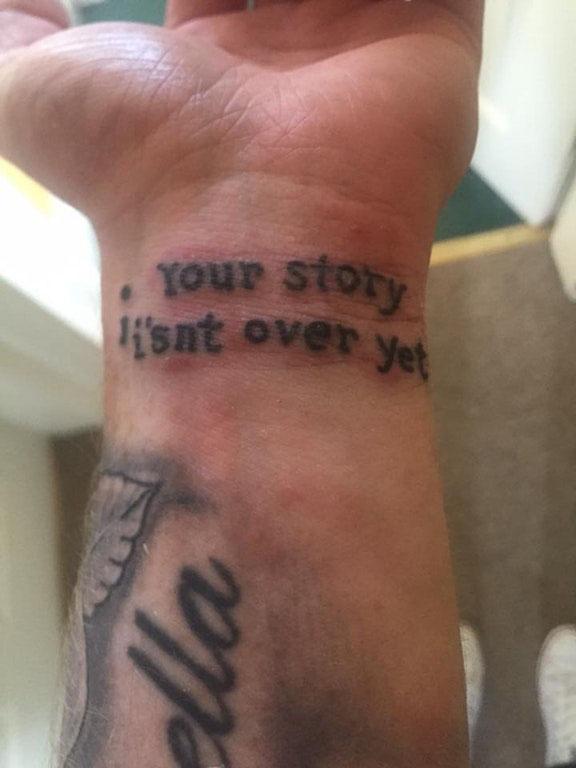  We're not quite sure why the tattooist popped the apostrophe in between the 'i' and the 's'