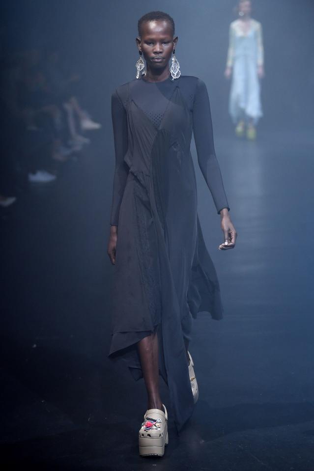  A model proudly wears a silver pair of platform Crocs on the catwalk