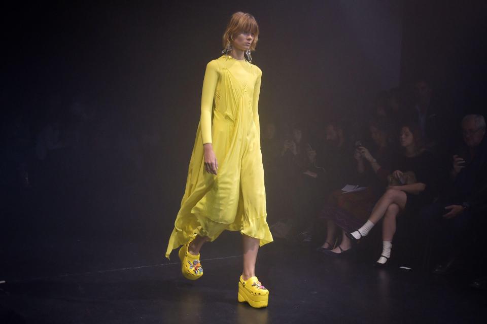  A model plods along in a bright yellow pair at the Paris catwalk show