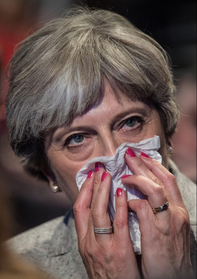  Theresa May blows her nose as she listens to conference speakers