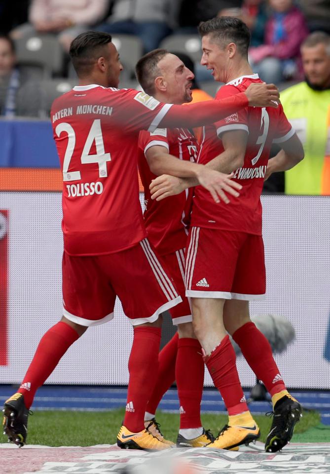  The Polish hitman celebrates with his team-mates after doubling Bayern's lead