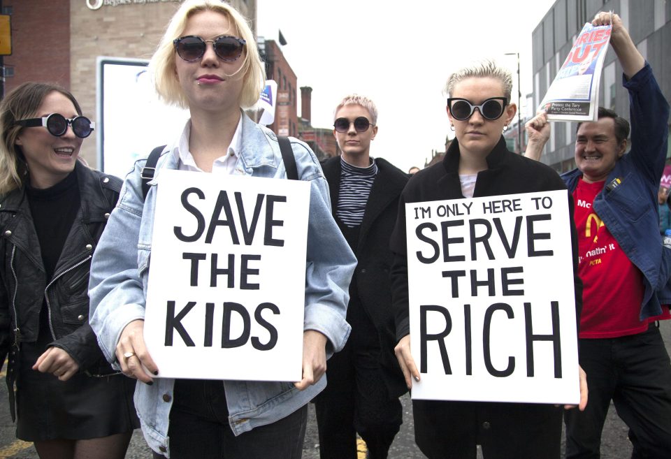  Young anti-Conservative protesters wave placards in Manchester