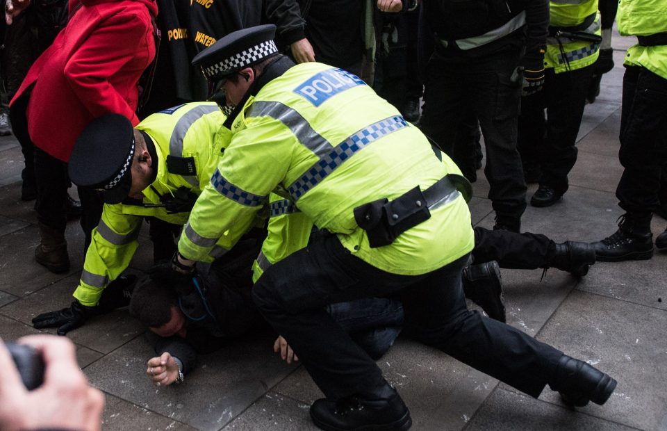  Police arrest a man during the Manchester demonstration