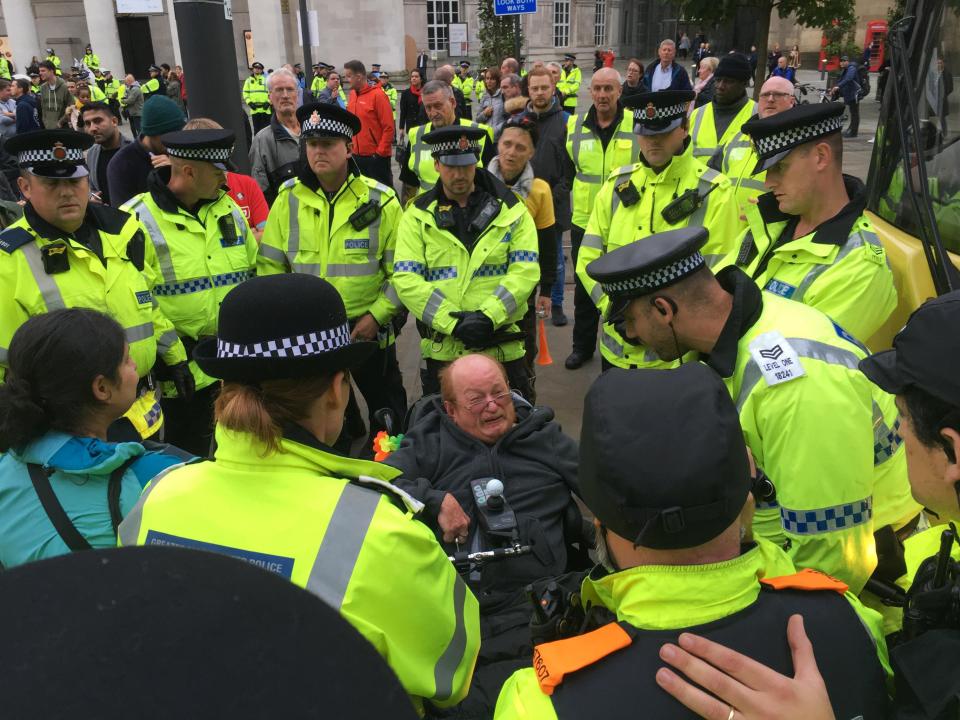  A disabled protester was surrounded by police after blocking tram tracks