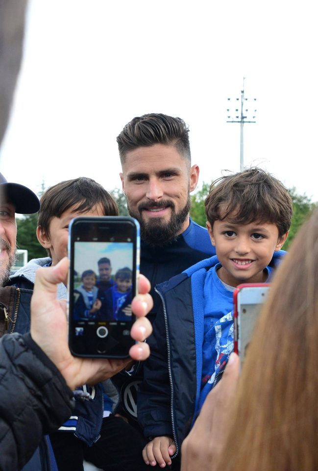  Fans fight for a snap with the Frenchman at France's training session