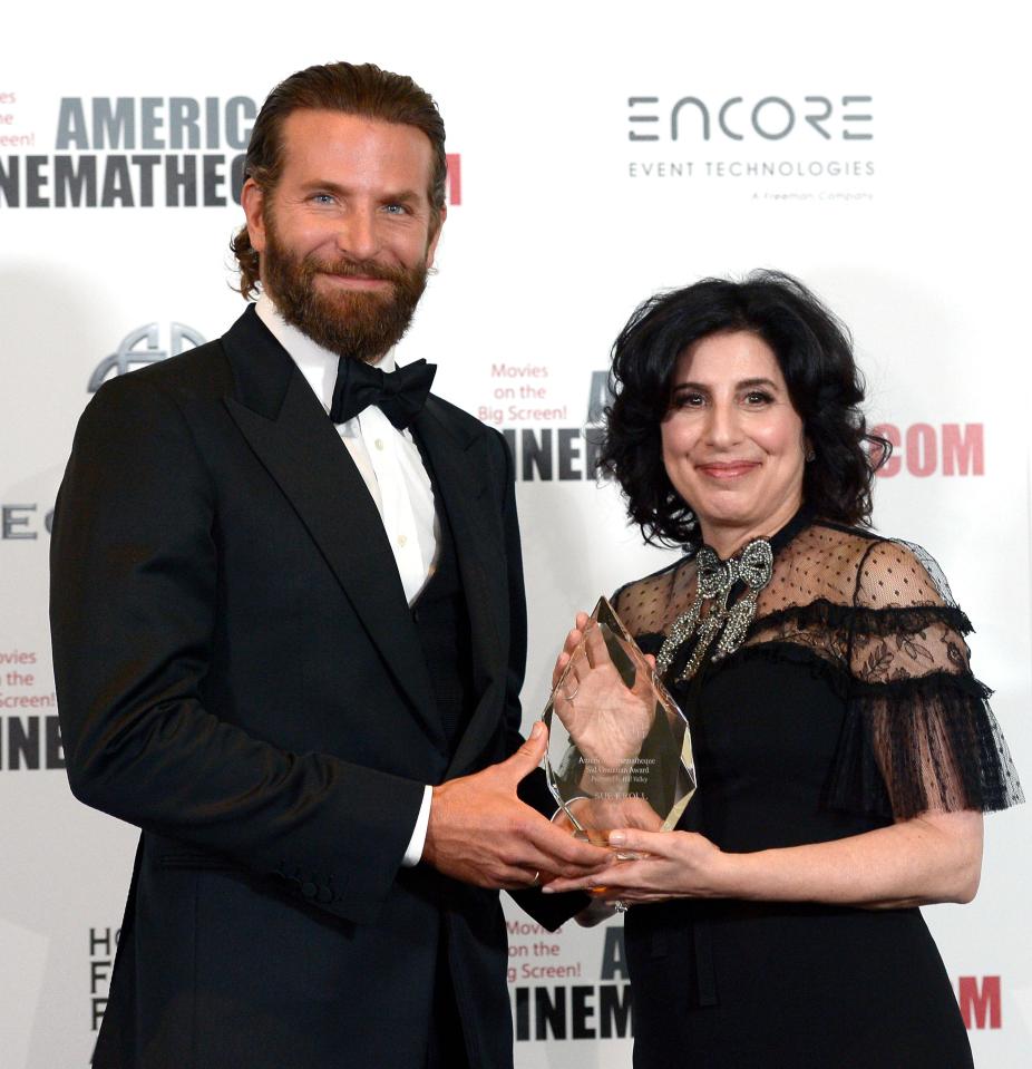 Bradley Cooper (L) and honoree Sue Kroll pose with the Sid Grauman Award during the 30th Annual American Cinematheque Awards Gala