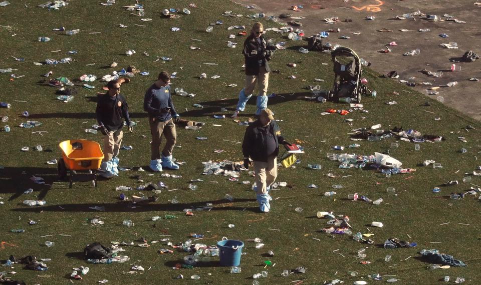 Investigators walk through debris on festival grounds across the street from the Mandalay Bay Resort