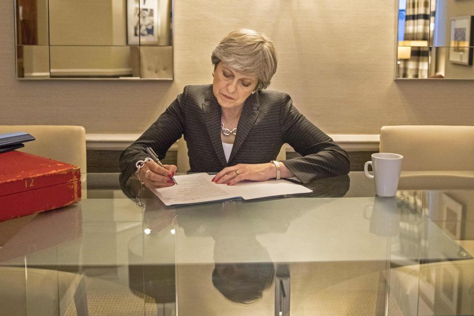  Mrs May writing her speech, in a picture shared last night