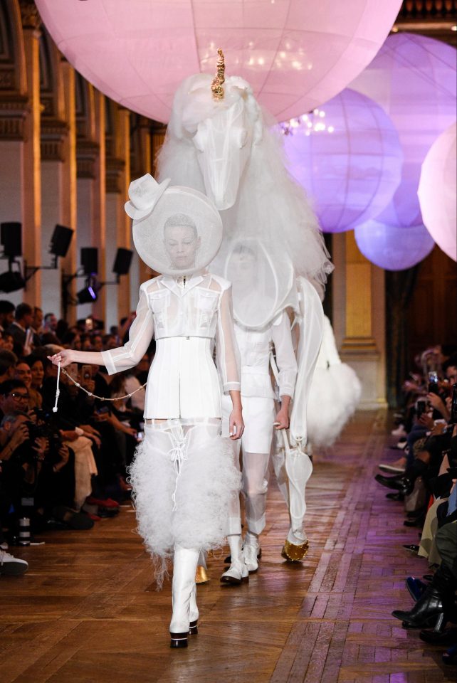  The finale of the runway show included a robotic unicorn dressed in a matching white lace look