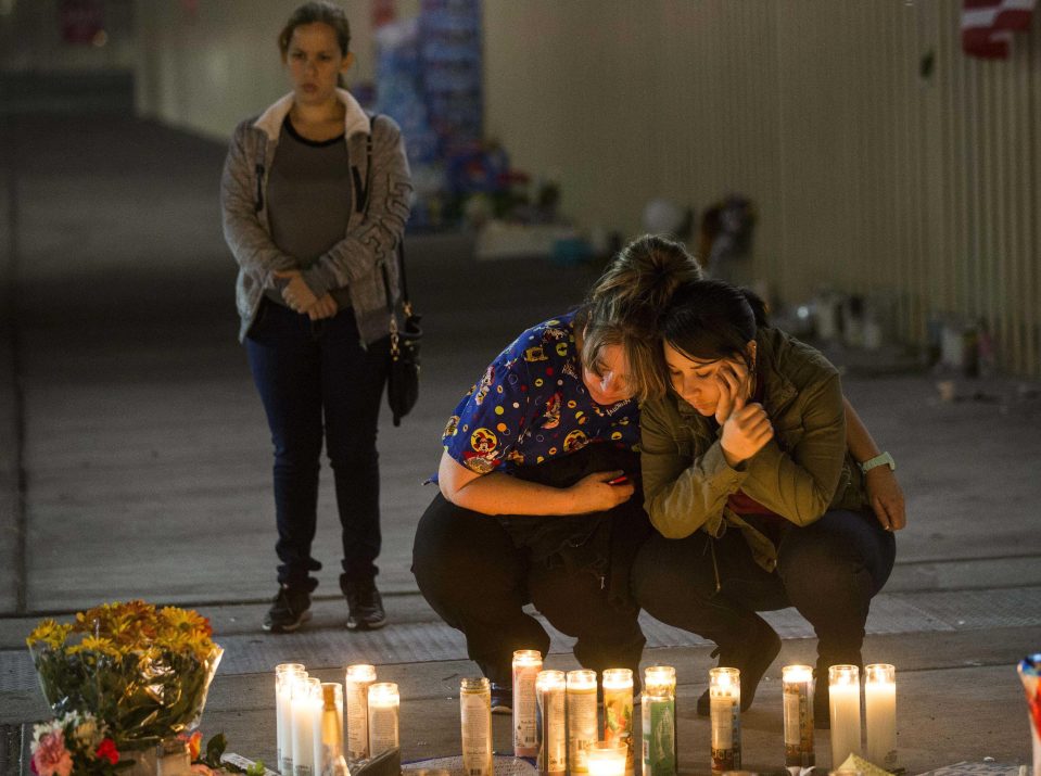  Locals burn a candle at the memorial site on Las Vegas Blvd