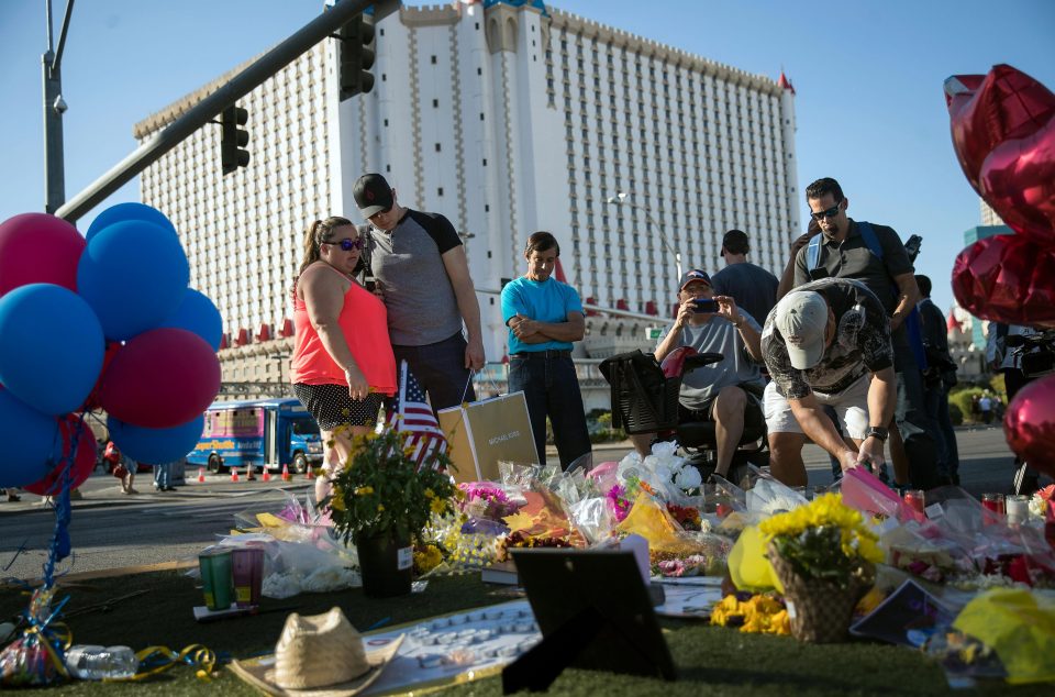  People in Las Vegas create a makeshift memorial near the site of Sunday night's mass shooting