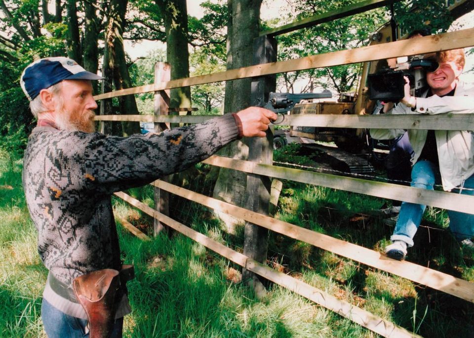  Albert Dryden takes aim with his pistol before shooting dead planning officer Harry Collinson