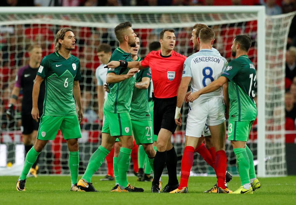 Referee Felix Zwayer breaks up a clash between England’s Harry Kane and Slovenia’s Bostjan Cesar