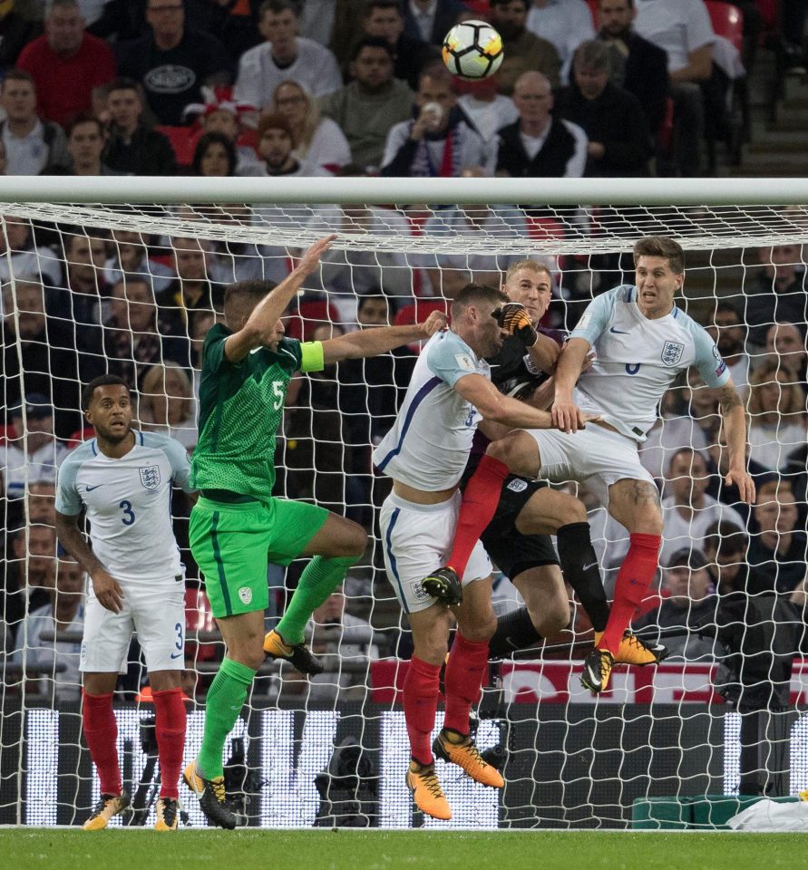 Joe Hart rushes out to punch clear of a crowd of players