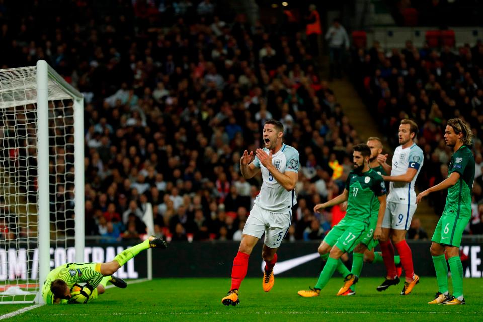 Gary Cahill sees an effort saved by Slovenia keeper Jan Oblak