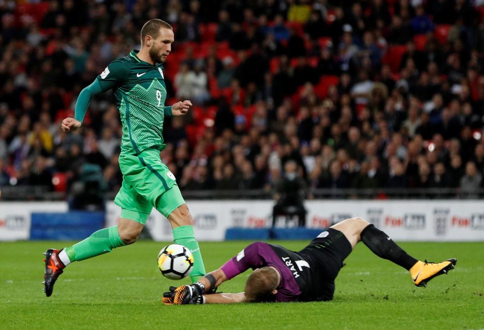  Joe Hart gets down to deny Slovenia’s Tim Matavz late on