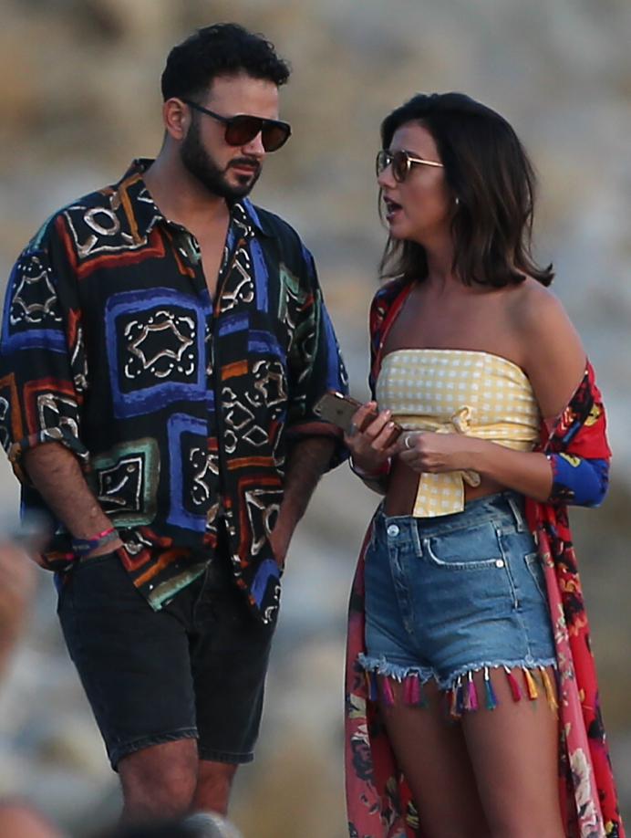  Lucy showed off her deep tan in denim shorts and a yellow crop top