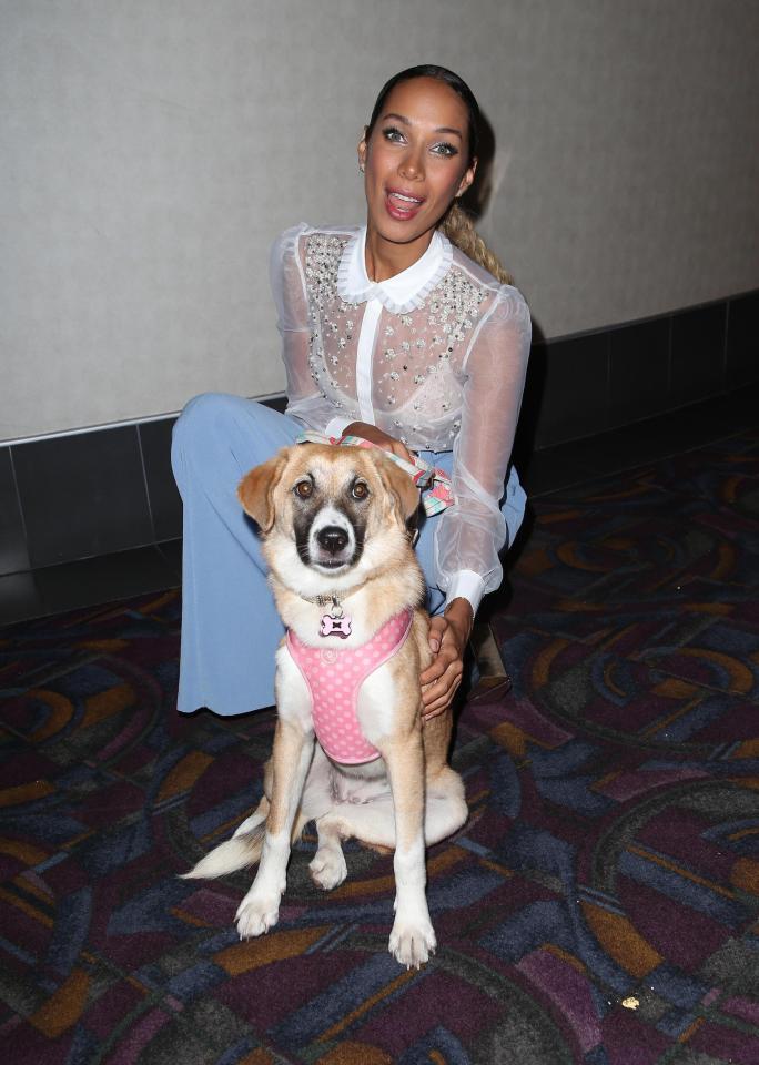  She giggled as she posed with an adorable dog