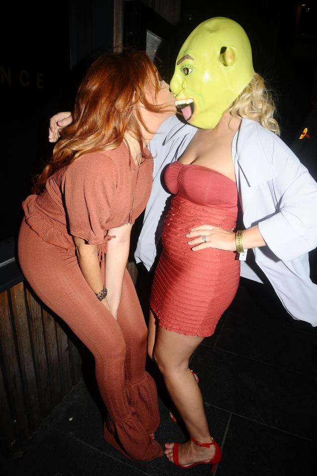  Wayne Rooney party girl Laura Simpson plants a kiss on a pal wearing a Shrek mask