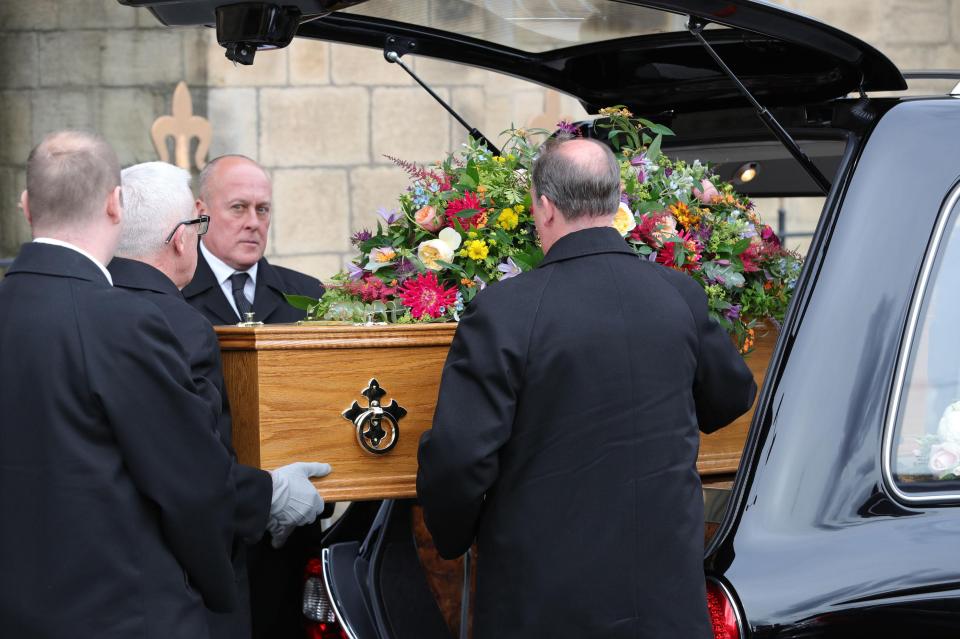  The coffin was laden with floral tributes