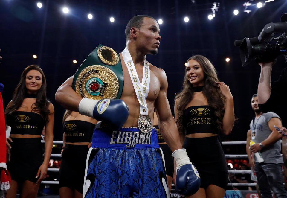 Chris Eubank Jnr celebrates his win with ring girls in the background