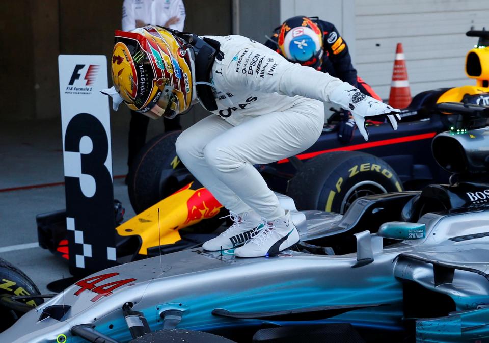 Lewis Hamilton jumps out of his car after extending his commanding lead