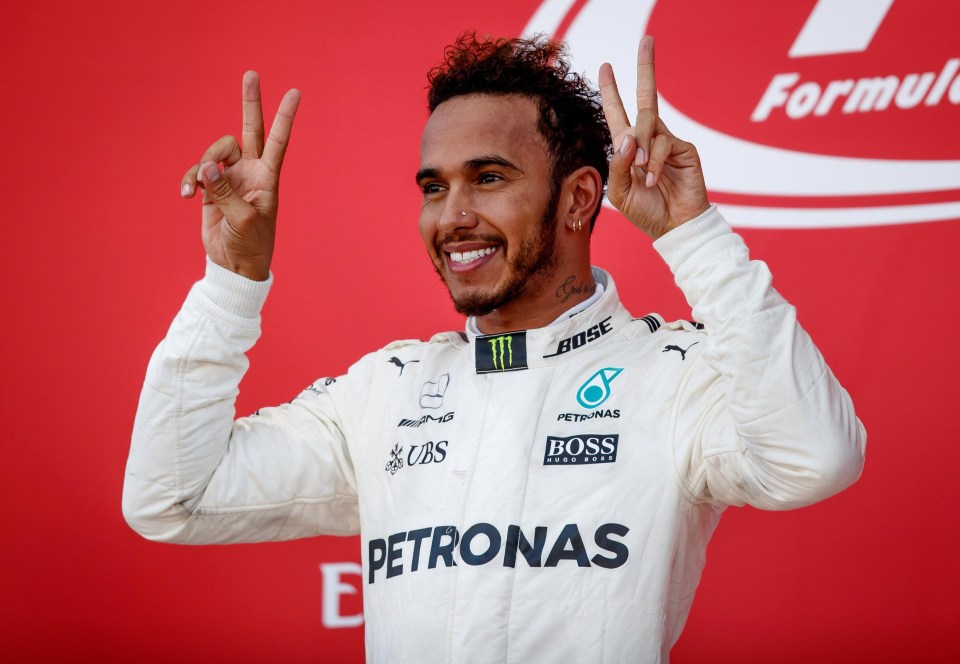 Lewis Hamilton gives a V for victory at the Japanese Grand Prix