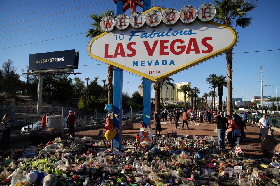  Tributes surround the famous Las Vegas sign at a makeshift memorial for victims