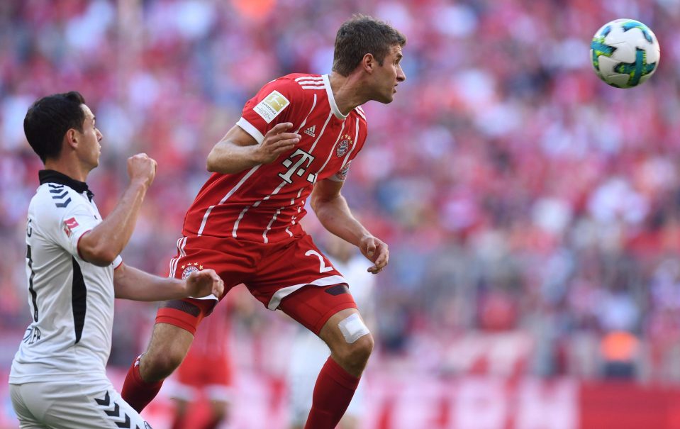 Freiburg midfielder Nicolas Hoefler tries to close on Bayern Munich's experienced striker Thomas Muller