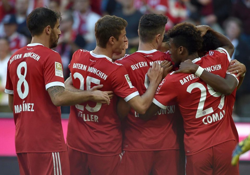 Bayern celebrate their own-goal opener from Freiburg’s Julian Schuster