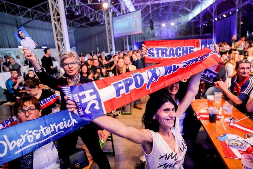  Supporters of the leader of the right-wing Austrian Freedom Party (FPOe) Heinz-Christian Strache (not pictured) react as they watch a projection of the Austrian Federal Elections in Vienna, Austria