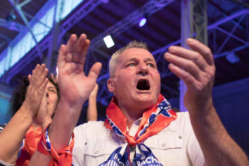  A supporter of Austria's far-right Freedom Party (FPOe) celebrates as first exit polls are published during the party's election