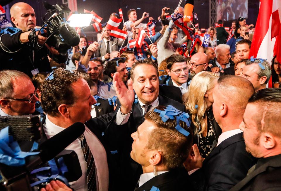  The leader of the right-wing Austrian Freedom Party (FPOe) Heinz-Christian Strache (C) waves as he arrives for the FPOe's election party after the Austrian Federal Elections