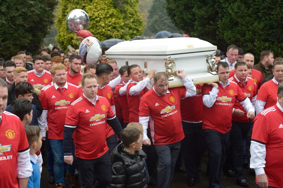 Scores of mourners wore Manchester United shirts over their shirts in tribute to football-mad Tom