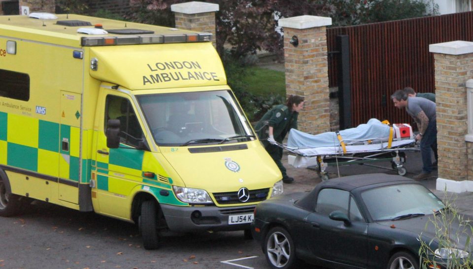  A medic lifts Simon Cowell onto an ambulance on a stretcher after falling down the stairs in London