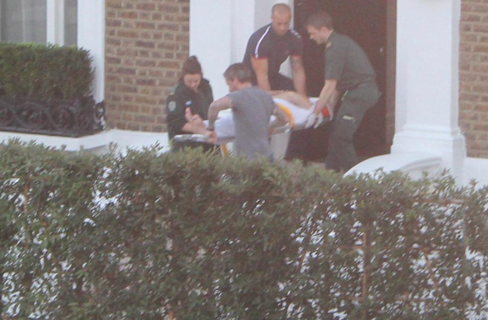  Picture shows Simon Cowell leaving his house on a stretcher after falling down his steep staircase