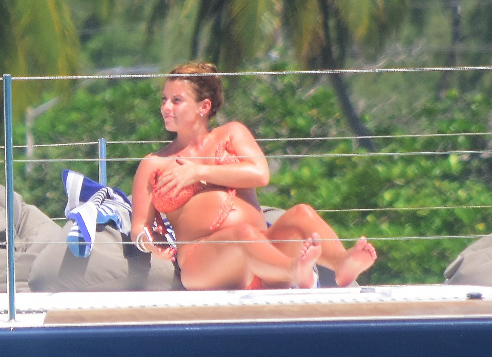 As she spent some time on her phone, she appeared to struggle to keep her pretty bikini in place