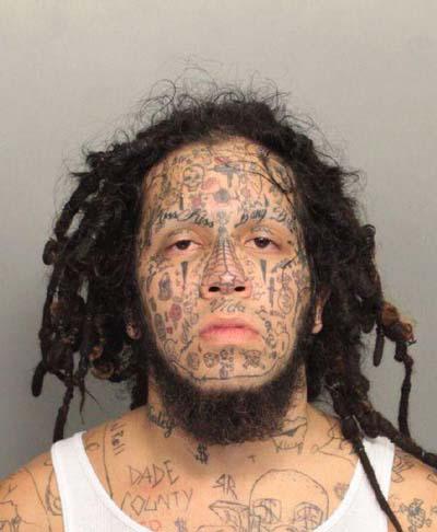  What was this man inking? His face features more than a dozen tiny tattoos